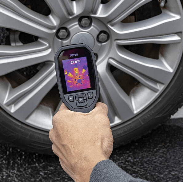 Thermal imaging device scanning a car wheel